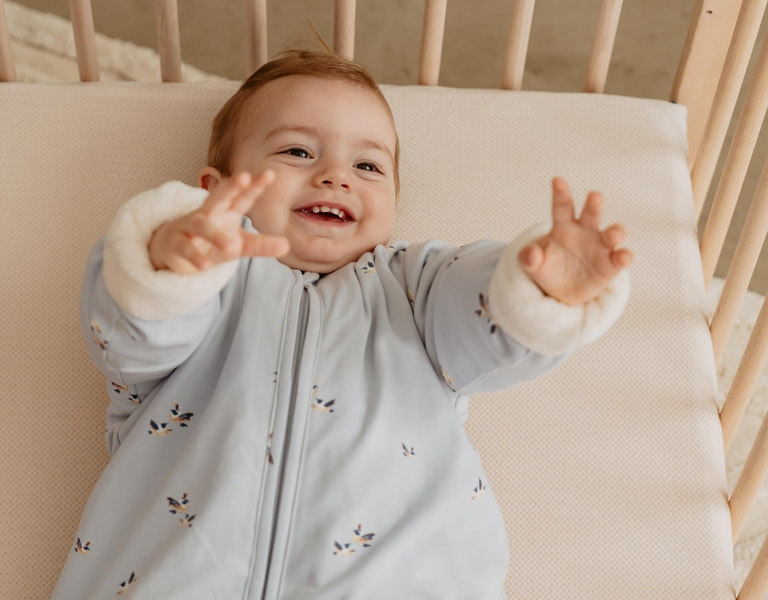 newborn baby in a piep sleeping bag