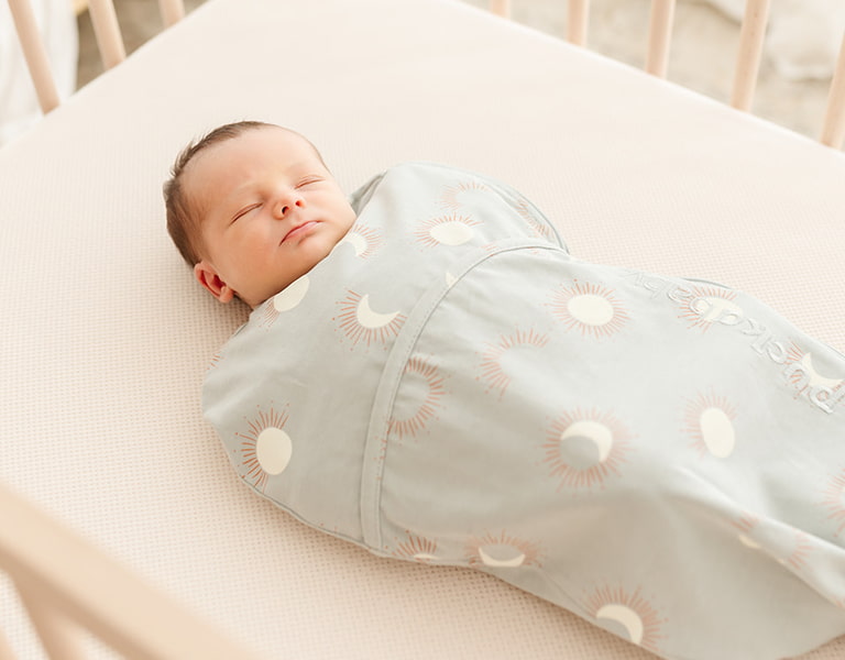 newborn baby in a piep sleeping bag