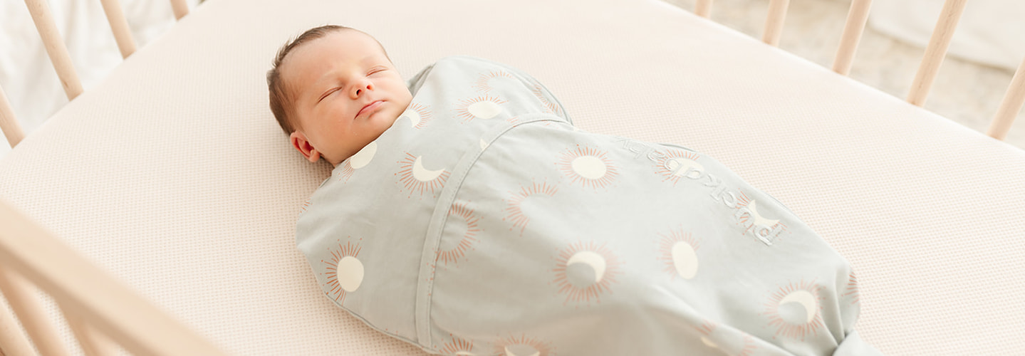 newborn baby in a piep sleeping bag